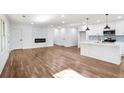 Spacious living room featuring a modern fireplace and a kitchen with an island at 1321 Avon Sw Ave, Atlanta, GA 30310