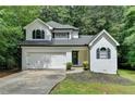 Charming two-story home with a well-manicured lawn, garage, and classic architectural details at 4278 Trotters Ln, Auburn, GA 30011