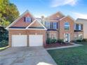 Charming two-story brick home with a well-manicured lawn and a two-car garage at 6260 Selborn Sw Dr, Atlanta, GA 30331