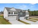 New construction townhomes with modern architecture, attached garages, and manicured landscaping at 6427 Rosetta Dr # 64, South Fulton, GA 30331