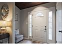 Inviting front foyer with a white front door, sidelights, a decorative sunburst mirror, and a charming bench at 783 Lost Creek Cir, Stone Mountain, GA 30088