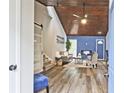 Bright living room with a wood plank ceiling, modern fireplace, stylish furniture, and a barn door at 783 Lost Creek Cir, Stone Mountain, GA 30088