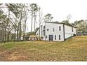 View of the rear of the home with its exterior, yard, and deck overlooking the serene surroundings at 783 Lost Creek Cir, Stone Mountain, GA 30088