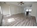 Spacious living area featuring a view of the stairs, wood-like flooring, and an open kitchen at 1560 Iris Walk, Jonesboro, GA 30238