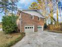 Two-car garage with a brick exterior and a concrete driveway at 2240 Spalding Dr, Marietta, GA 30062