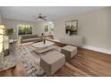 Bright living room with modern furniture, wood floors, and a stone fireplace at 2240 Spalding Dr, Marietta, GA 30062