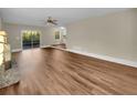 Spacious living room featuring wood flooring, a stone fireplace, and a sliding glass door at 2240 Spalding Dr, Marietta, GA 30062