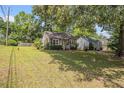 Single-story home with a large yard, offering ample space and a detached garage at 3146 Alston Dr, Decatur, GA 30032
