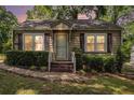 Charming single-story home featuring a cozy front porch and well-maintained landscaping at sunset at 3146 Alston Dr, Decatur, GA 30032