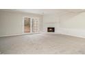 Bright living area with a white fireplace, a large window and a neutral carpet at 7004 Pat Mell Se Pl, Smyrna, GA 30080