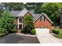 Traditional two-story brick home with well-maintained landscaping and a classic architectural design at 220 Galesburg Dr, Lawrenceville, GA 30044