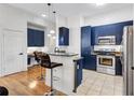 Modern kitchen with stainless steel appliances, granite countertops, and stylish bar seating at 400 17Th Nw St # 1119, Atlanta, GA 30363