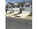 View of multiple two-story homes featuring attached garages and well-kept lawns at 6423 Rosetta Drive, Unit 66 # 66, South Fulton, GA 30331