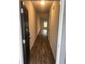 Hallway with wood floors and a window at the end for natural light at 6423 Rosetta Drive, Unit 66 # 66, South Fulton, GA 30331