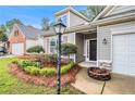 Inviting home exterior with tidy flower beds, established shrubs, and a well-manicured lawn at 712 Brambling Way, Stockbridge, GA 30281