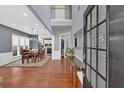 Grand foyer featuring hardwood floors, a staircase, and an open view of the dining and kitchen areas at 813 Poplar Ter, Canton, GA 30115