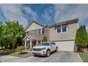 Inviting two-story townhome with attached garage, well-kept lawn, and a brick and siding facade at 1570 Shire Village Dr, Sugar Hill, GA 30518