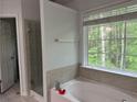 Bright bathroom featuring a soaking tub and a glass enclosed shower at 2107 Hailston Dr, Duluth, GA 30097