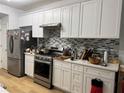 Modern kitchen with stainless steel appliances and white cabinetry at 2107 Hailston Dr, Duluth, GA 30097