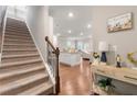 Entryway with staircase and an open floor plan leading to the kitchen and living areas at 2170 Trelipe Dr, Lawrenceville, GA 30044