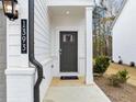Close up of the front door with the house number and a small bush on the side at 1393 Halpern Nw Ln, Kennesaw, GA 30144