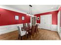 Dining room showcases bold red walls, white trim, and a modern glass table at 194 Sentinel Se Pl, Marietta, GA 30067