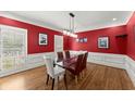 Dining room showcases bold red walls, white trim, and a modern glass table at 194 Sentinel Se Pl, Marietta, GA 30067