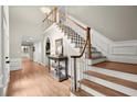 Spacious foyer with staircase, hardwood floors, and a decorative table displaying elegant decor at 194 Sentinel Se Pl, Marietta, GA 30067
