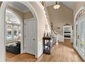 Inviting foyer boasts hardwood floors, arched doorways, and staircase with natural light at 194 Sentinel Se Pl, Marietta, GA 30067