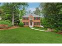 Beautiful brick home with lush green lawn, mature trees, and well-maintained landscaping at 2622 Murdock Rd, Marietta, GA 30062