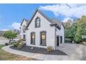 Charming two-story home featuring white painted brick, dark trim, and well-maintained landscaping at 4519 Mossey Dr, Lithonia, GA 30038
