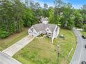 Spacious property featuring a well-manicured lawn, long driveway, and lush landscaping at 5008 Monticello Dr, Villa Rica, GA 30180