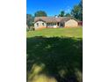Spacious backyard featuring a large lawn, wooden deck, and charming patio area at 1311 N Brandy Se Shls, Conyers, GA 30013