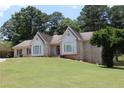 Beautiful single-story brick home with large windows and a well-maintained front lawn at 1311 N Brandy Se Shls, Conyers, GA 30013