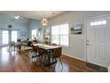 Open-concept dining area showcasing hardwood floors and natural light at 2410 Clock Face Ct, Lawrenceville, GA 30043
