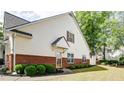 Home exterior featuring brick accents and lush green lawn at 2410 Clock Face Ct, Lawrenceville, GA 30043