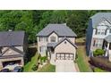 An aerial view of the brick home showing its roof, landscaping, and proximity to neighboring houses at 456 Crestmont Ln, Canton, GA 30114
