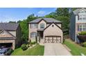 Inviting two-story home with well-kept lawn and a two-car garage nestled among mature trees at 456 Crestmont Ln, Canton, GA 30114