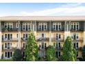 Apartment building featuring multiple units with balconies and lush green trees in front at 1195 Milton Se Ter # 1407, Atlanta, GA 30315