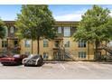 Apartment complex with parking, stairs to units, and mature shade trees on a sunny day at 1195 Milton Se Ter # 1407, Atlanta, GA 30315