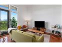 Bright living room boasts hardwood floors, modern furniture, and natural light from large windows with a city view at 1195 Milton Se Ter # 1407, Atlanta, GA 30315