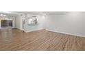 Bright living room with wood floors and sliding glass door to backyard at 305 Winding River Village Dr # F, Atlanta, GA 30350
