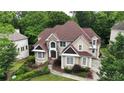 Stately two-story home featuring a stone façade, manicured landscaping, and a charming walkway to the front door at 5309 Ashley Trce, Atlanta, GA 30360