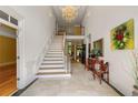 Grand foyer with a chandelier, staircase, and travertine flooring at 5309 Ashley Trce, Atlanta, GA 30360