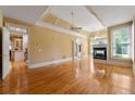 Open living room featuring hardwood floors, a fireplace, and abundant natural light at 5309 Ashley Trce, Atlanta, GA 30360