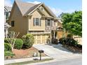 Charming home with manicured landscaping and a two-car garage, set in a neighborhood at 8360 Village School Dr, Cumming, GA 30041