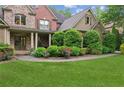 Charming home with brick and stone accents, lush landscaping, and a walkway to the front door at 2840 Astoria Ave, Cumming, GA 30040