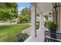 Relaxing front porch with ample seating, decorative shrubbery, and views of the manicured lawn at 1042 Trailridge Pl, Atlanta, GA 30338