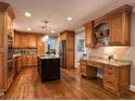 Spacious kitchen with wood cabinetry, granite countertops, stainless steel appliances, and a center island at 1042 Trailridge Pl, Atlanta, GA 30338