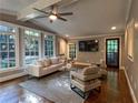 Bright living room featuring hardwood floors, large windows, and modern neutral-toned furniture at 1042 Trailridge Pl, Atlanta, GA 30338